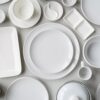 Top view of white tableware on white background